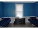 Bright bedroom features blue walls, new vinyl floors, two beds, natural light, and a dresser at 10095 N Walnut St St, Middlesex, NC 27557