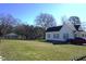Charming single Gathering home with blue shutters, mature trees, spacious yard, and ample parking at 10095 N Walnut St St, Middlesex, NC 27557