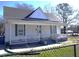 Inviting home showcasing a classic covered porch, with ample seating and fresh curb appeal at 10095 N Walnut St St, Middlesex, NC 27557