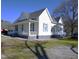 Lovely home displaying a spacious front porch, complemented by a well-manicured lawn at 10095 N Walnut St St, Middlesex, NC 27557