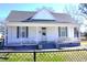Charming home featuring a covered front porch, white siding, and a well-maintained lawn at 10095 N Walnut St St, Middlesex, NC 27557
