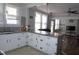 Open concept kitchen with breakfast bar, stainless sink, lots of natural light and white cabinets at 10095 N Walnut St St, Middlesex, NC 27557