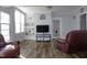 Comfortable living room boasts a large window, new floors, and neutral tones, perfect for relaxation at 10095 N Walnut St St, Middlesex, NC 27557