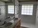 Bathroom featuring double sinks and a walk-in shower with safety bars at 103 Kiowa Cv, Louisburg, NC 27549