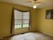 Sunny bedroom with ceiling fan, window and decorative framed picture at 103 Kiowa Cv, Louisburg, NC 27549
