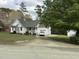 Charming one-story home with white siding, black shutters, covered front porch, and an attached garage at 103 Kiowa Cv, Louisburg, NC 27549