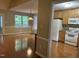 Open kitchen with white appliances, stone countertops and breakfast bar at 103 Kiowa Cv, Louisburg, NC 27549
