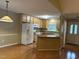 View of the kitchen, featuring white appliances, stone countertops, and pendant lighting at 103 Kiowa Cv, Louisburg, NC 27549