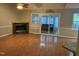 Living room with a fireplace, wood floors, and view of the sunroom at 103 Kiowa Cv, Louisburg, NC 27549