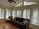 Sun room with hardwood floors, seating, ceiling fan and lots of windows at 103 Kiowa Cv, Louisburg, NC 27549