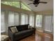 Sun room with hardwood floors, seating, ceiling fan and exterior access at 103 Kiowa Cv, Louisburg, NC 27549