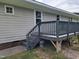 This home includes a dark gray wooden deck, accessible from the back of the house at 1033 Silas Moore Rd, Benson, NC 27504