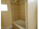 Inviting bathroom with a relaxing tub, neutral tile, and natural light from window at 1033 Silas Moore Rd, Benson, NC 27504