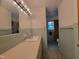 Bathroom features a long countertop with a sink, a large mirror, and retro tile at 1033 Silas Moore Rd, Benson, NC 27504