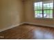 Comfortable bedroom with laminated floors and a large window offering pleasant views at 1033 Silas Moore Rd, Benson, NC 27504