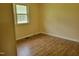 Cozy bedroom with hardwood floors and a large window providing natural light at 1033 Silas Moore Rd, Benson, NC 27504