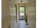Bright hallway with tile flooring, leading to an exit door and featuring ample closet space at 1033 Silas Moore Rd, Benson, NC 27504