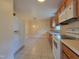 Practical kitchen with white appliances and warm-toned cabinets for a cozy feel at 1033 Silas Moore Rd, Benson, NC 27504