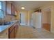 Functional kitchen with stainless steel sink, ample cabinets, and white appliances at 1033 Silas Moore Rd, Benson, NC 27504
