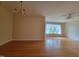 Spacious living room with hardwood floors, large windows, and classic chandelier at 1033 Silas Moore Rd, Benson, NC 27504
