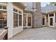 A charming back porch featuring a brick fireplace and white trim windows at 10370 Spaight, Chapel Hill, NC 27517