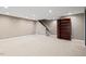 Spacious basement area with a staircase, shelving unit, and recessed lighting throughout at 10370 Spaight, Chapel Hill, NC 27517