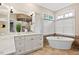 Elegant bathroom featuring a soaking tub, double vanity, and modern finishes at 10370 Spaight, Chapel Hill, NC 27517