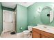 Bathroom features a tile shower, toilet, and a vanity with a sink and wood cabinets at 10370 Spaight, Chapel Hill, NC 27517