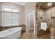 Bathroom featuring soaking tub, walk-in shower, and neutral color palette at 10370 Spaight, Chapel Hill, NC 27517