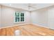 Bedroom with a ceiling fan, hardwood floors, and a window offering natural light at 10370 Spaight, Chapel Hill, NC 27517