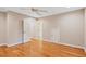 Bedroom with wood floors, a ceiling fan, and multiple doors to additional rooms at 10370 Spaight, Chapel Hill, NC 27517