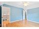 Bedroom with hardwood floors, blue walls, and an attached hallway and staircase at 10370 Spaight, Chapel Hill, NC 27517