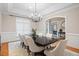 Dining room featuring an elegant chandelier and classic white chair rail molding at 10370 Spaight, Chapel Hill, NC 27517