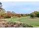Scenic view of lush green golf course with a serene pond at 10370 Spaight, Chapel Hill, NC 27517