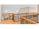 Hallway boasts hardwood floors, wood and iron banisters, and natural light at 10370 Spaight, Chapel Hill, NC 27517