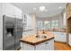 Bright kitchen with a butcher block island, stainless steel refrigerator, and ample counter space at 10370 Spaight, Chapel Hill, NC 27517