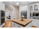Kitchen with a butcher block island, stainless steel appliances, and stylish cabinetry at 10370 Spaight, Chapel Hill, NC 27517