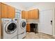 Efficient laundry room with a utility sink, washer, dryer, and plenty of cabinet storage at 10370 Spaight, Chapel Hill, NC 27517
