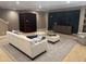 Cozy living area includes dark shelving, TV, and comfortable sofa and ottomans at 10370 Spaight, Chapel Hill, NC 27517