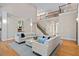 Spacious living room with a balcony overlooking the seating, hardwood floors, and neutral colors at 10370 Spaight, Chapel Hill, NC 27517