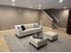 Cozy living room features a sofa, patterned ottomans, and neutral color palette at 10370 Spaight, Chapel Hill, NC 27517