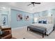Stylish main bedroom with light blue walls and elegant upholstered bed at 10370 Spaight, Chapel Hill, NC 27517