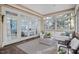 Bright sunroom features neutral tones and multiple windows at 10370 Spaight, Chapel Hill, NC 27517