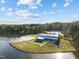 Aerial view of waterfront property with lake access, a sandy beach, and a blue building with a metal roof at 104 Stage Line Cv, Louisburg, NC 27549