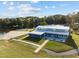 Aerial view of waterfront building featuring a metal roof, a sandy beach, and outdoor picnic seating at 104 Stage Line Cv, Louisburg, NC 27549
