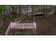 Backyard featuring access steps down to the lake, landscaping, and an elevated back deck at 104 Stage Line Cv, Louisburg, NC 27549