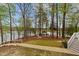 A backyard featuring a walkway leading to a gazebo near the lake at 104 Stage Line Cv, Louisburg, NC 27549