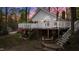 Backyard featuring an elevated deck with stairs down to the lawn and lake views at 104 Stage Line Cv, Louisburg, NC 27549
