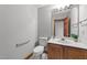 Bathroom featuring tiled floors, vanity with white countertop and wooden cabinet at 104 Stage Line Cv, Louisburg, NC 27549