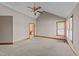 Spacious bedroom with a vaulted ceiling, neutral carpet, and a door leading to the bathroom at 104 Stage Line Cv, Louisburg, NC 27549